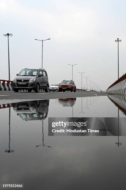 Commuters seen out during light rains at Sector 31-25 road, on February 3, 2024 in Noida, India.