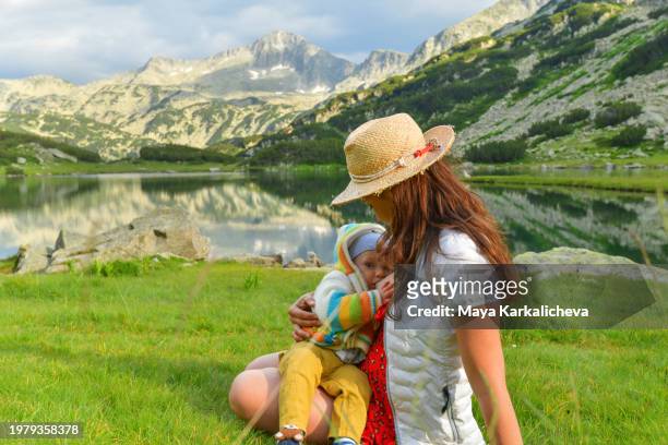 mother breastfeeding while hiking in a mountain - bansko stock pictures, royalty-free photos & images