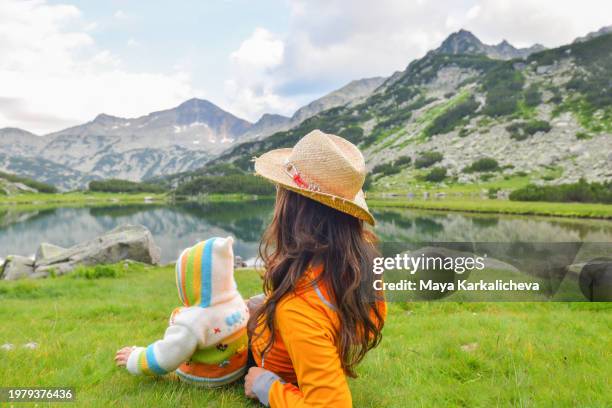 mother with baby enjoying beautiful view to mountain lake - bansko stock pictures, royalty-free photos & images