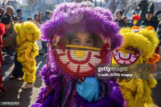 Kids dressed as Chinese lions seen during the Chinese New Year Parade. Barcelona's Chinese community joyously inaugurates the Chinese New Year...