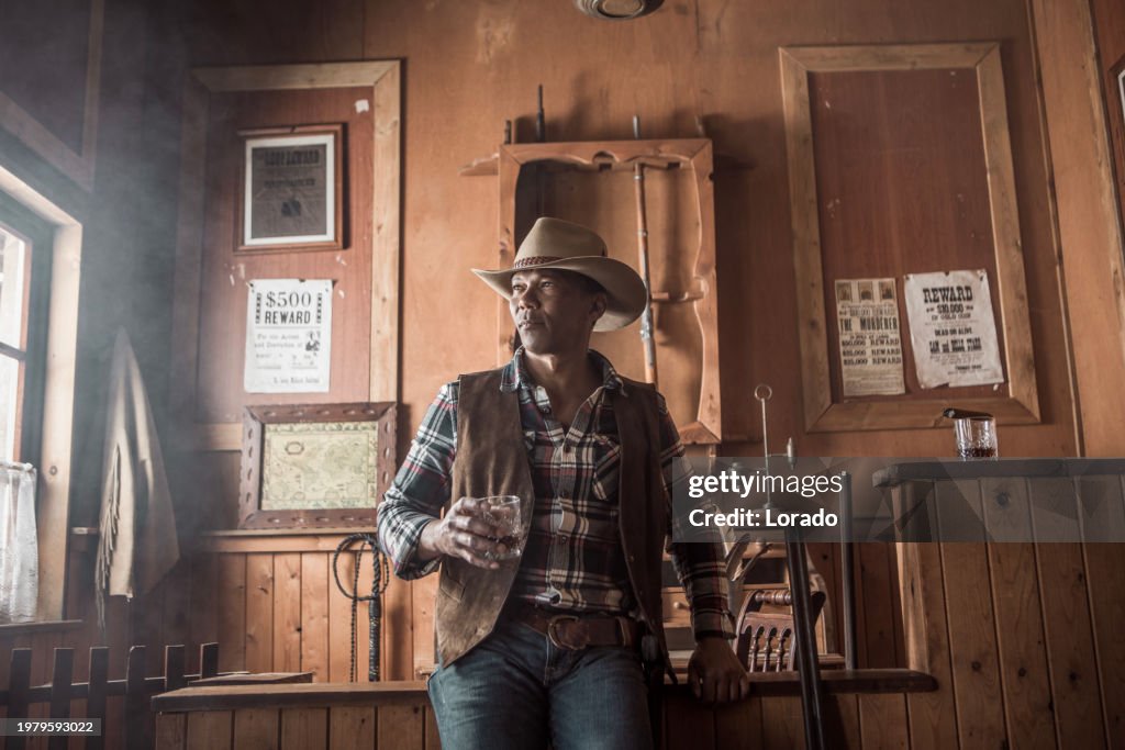Handsome Black Cowboy in an authentic wild west setting