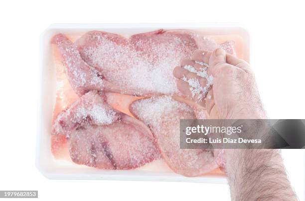 salting pig ears. - adding salt stock pictures, royalty-free photos & images