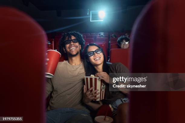 happy couple enjoying in a 3d movie at cinema. - couple in cinema seats stock pictures, royalty-free photos & images