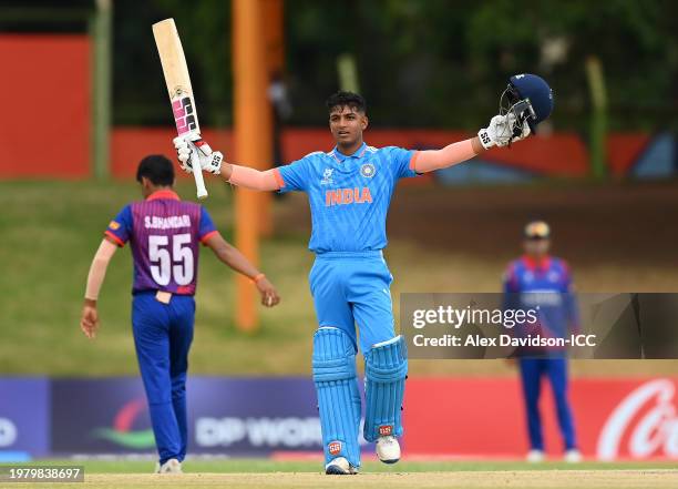 Sachin Dhas of India raises his bat and helmet as he celebrates after reaching his century during the ICC U19 Men's Cricket World Cup South Africa...