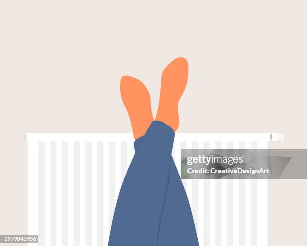 stockillustraties, clipart, cartoons en iconen met human feet in orange socks warming up on radiator - elektrische kachel