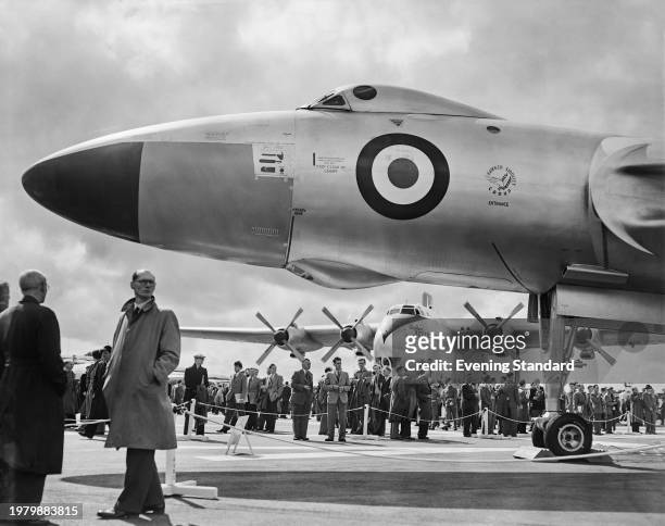 Visitors walk among aircraft, with the front section of Avro Vulcan B1 strategic bomber in the foreground and a Blackburn Beverley heavy transport...