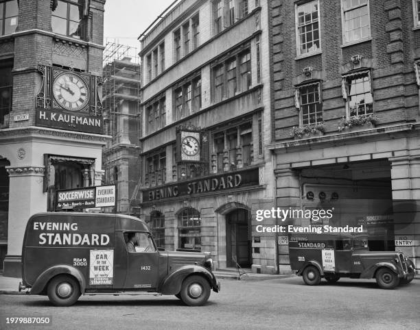 An Austin FL1 Evening Standard delivery van and a Humber Evening Standard delivery van parked outside the newspaper's offices on Shoe Lane, off Fleet...