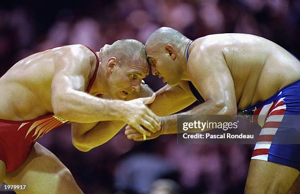 Alexander Karelin of Russia and Siamak Ghaffari of the USA square up to each other in their wrestling match on July 23, 1996 during the 1996 Olympic...