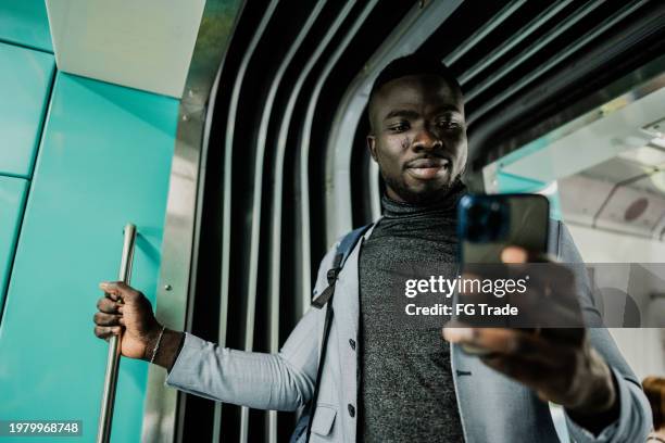businessman using the mobile phone on the train - subway train stock pictures, royalty-free photos & images
