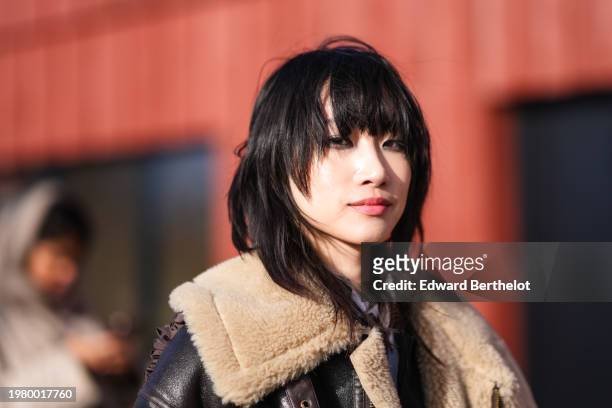 Model wears a brown aviator jacket with fluffy sheep wool inner lining, a shirt,red lipstick , make-up , outside Gestuz, during the Copenhagen...