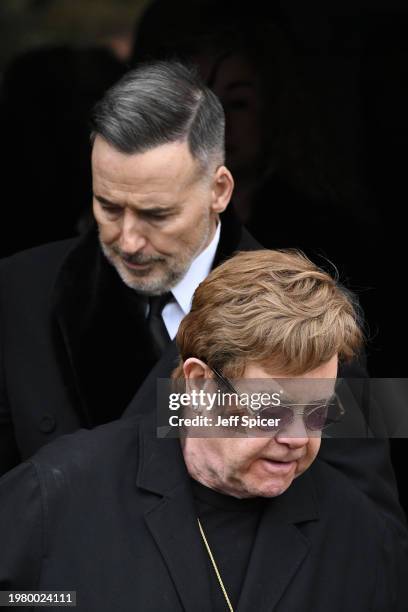 Elton John and David Furnish depart the funeral of Derek Draper at St Mary the Virgin Church, on February 02, 2024 in London, England.