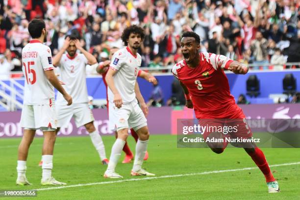 Abdallah Nasib of Jordan celebrates his team's first goal, an own goal scored by Vahdat Khanonov of Tajikistan during the AFC Asian Cup quarter final...