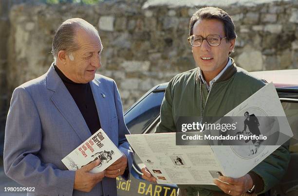 Italian singer Enzo Jannacci with Italian cyclist Gino Bartali shows the new Album of the singer in which there is the song Bartali dedicated to the...