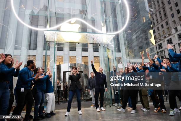 Apple CEO Tim Cook and Senior Vice President of Retail and People Deirdre O'Brien greet people as they prepare to open the Fifth Avenue Apple store...