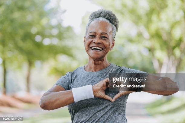 senior woman heart symbol - old black people exercising stock pictures, royalty-free photos & images