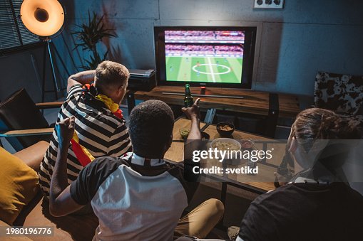 Friends watching soccer championship at home Friends watching soccer championship at home