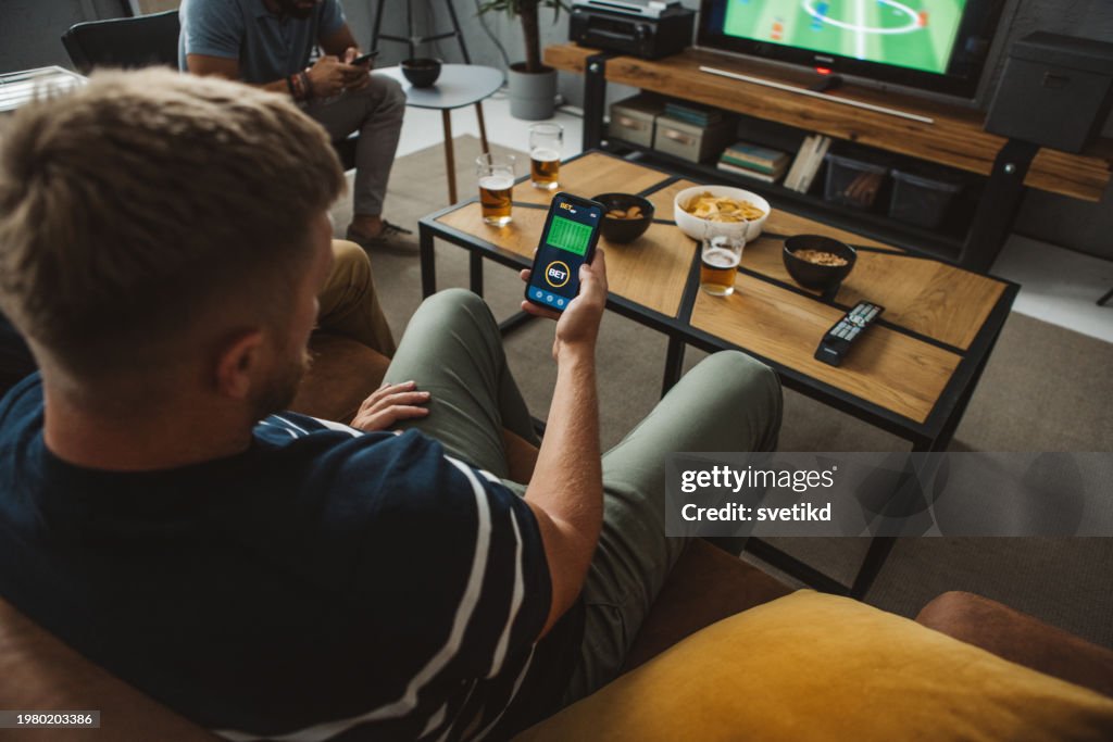 Friends watching soccer championship at home