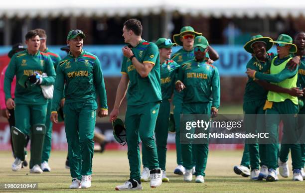 Juan James, Captain of South Africa, speaks with Riley Norton as they leave the field during the ICC U19 Men's Cricket World Cup South Africa 2024...
