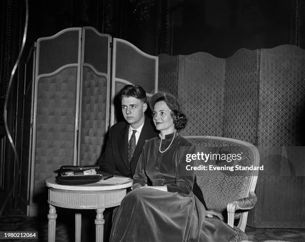 Albanian Royal Leka, Crown Prince of Albania, wearing a dark suit over a shirt and tie, and his mother, Queen Geraldine of Albania, who wears a...