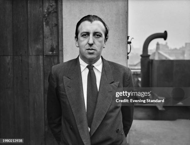 Evening Standard journalist Marius Pope, wearing a dark suit jacket over a white shirt and dark tie, in London, England, 22nd January 1957.