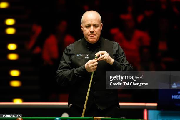 John Higgins of Scotland reacts in the quarter-final match against Judd Trump of England on day 5 of 2024 BetVictor German Masters at Tempodrom on...