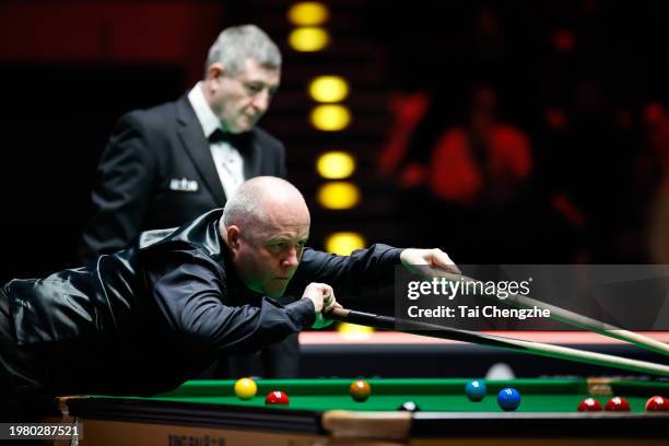 John Higgins of Scotland plays a shot in the quarter-final match against Judd Trump of England on day 5 of 2024 BetVictor German Masters at Tempodrom...