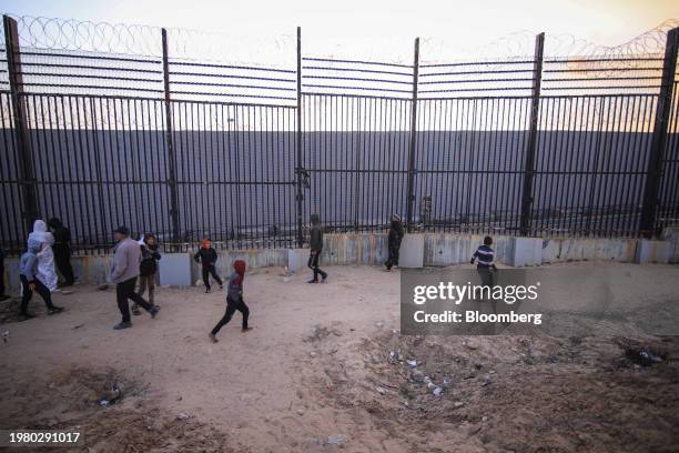 Displaced Palestinians beside the border wall with Egypt in Rafah, Gaza Strip, on Thursday. Feb. 1, 2024. Negotiations are advancing for an agreement...