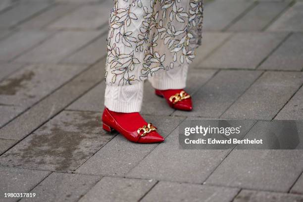 Close-up detail view of red socks and red pointed shoes with golden details, outside Munthe, during the Copenhagen Fashion Week AW24 on February 01,...