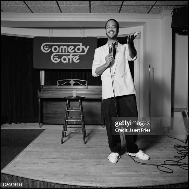 View of American stand-up comedian and weather forecaster Tony Perkins on stage at the Comedy Cafe, Washington DC, June 1987.