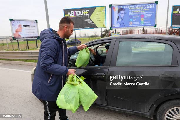 Farmers give away their products, fruit and vegetables, to passers-by in cars, during the demonstration to protest against the "Green Deal"...