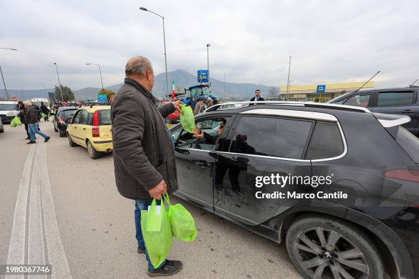 Farmers give away their products, fruit and vegetables, to passers-by in cars, during the demonstration to protest against the "Green Deal"...