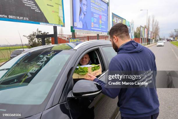 Farmers give away their products, fruit and vegetables, to passers-by in cars, during the demonstration to protest against the "Green Deal"...