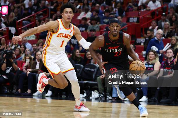 Jimmy Butler of the Miami Heat drives past Jalen Johnson of the Atlanta Hawks during the fourth quarter at Kaseya Center on January 19, 2024 in...