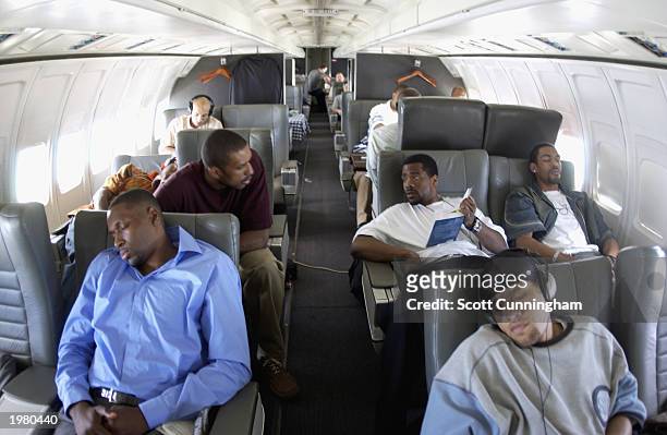 Jermaine Jackson , Mikki Moore , Theo Ratliff , Ira Newble of the Atlanta Hawks relax in the Hawks team plane on April 16, 2003 en route to New...