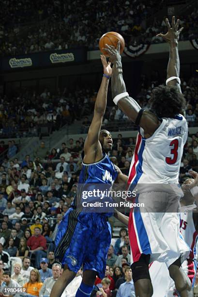 Tracy McGrady of the Orlando Magic shoots over Ben Wallace of the Detroit Pistons in Game seven of the Eastern Conference Quarterfinals during the...