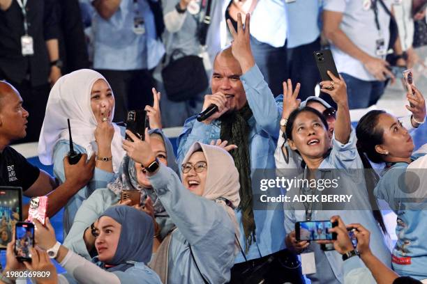 Indonesian musician Ahmad Dhani sings during an election campaign event of presidential candidate and Indonesia's Defence Minister Prabowo Subianto...