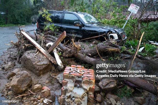 Studio City, CA Storm damage from mud, rock and debris flows along Lockridge road in Studio City, CA, has caused major damage to vehicles and houses...