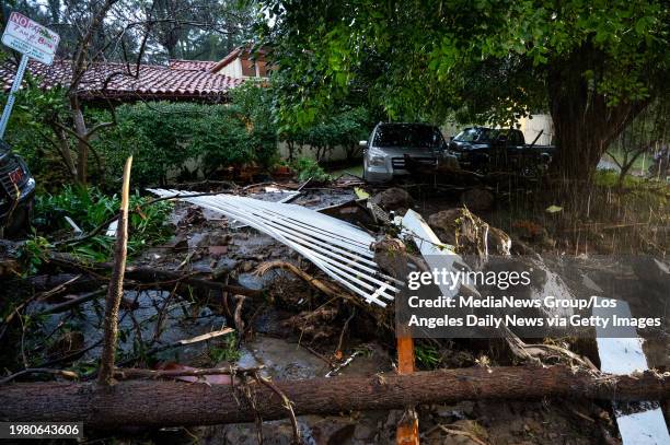 Studio City, CA Storm damage from mud, rock and debris flows along Lockridge road in Studio City, CA, has caused major damage to vehicles and houses...
