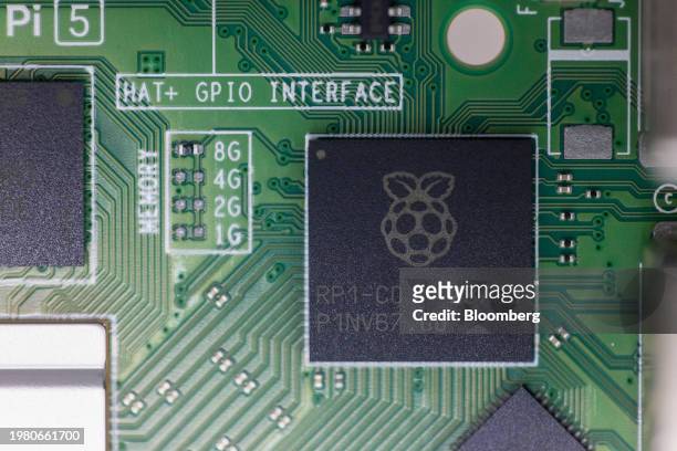 Microchip with a raspberry logo on a Raspberry Pi personal computer on the production line at the Sony UK Technology Centre in Pencoed, UK, on...
