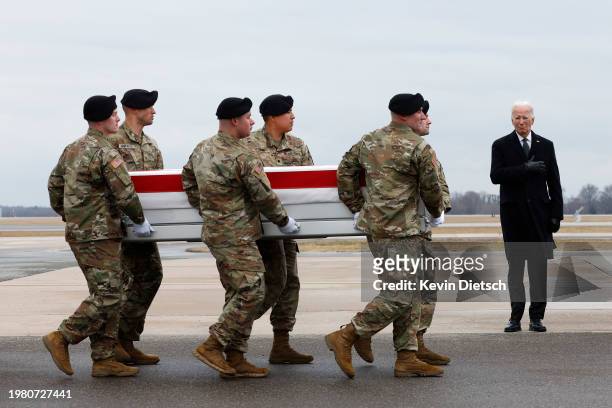 President Joe Biden salutes as a U.S. Army carry team moves a flagged draped transfer case containing the remains of Army Sgt. Kennedy Sanders during...