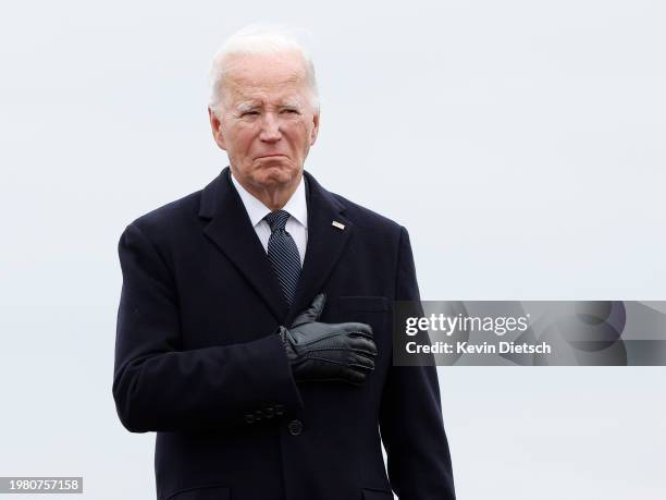 President Joe Biden places his hand over his heart during the dignified transfer for fallen service members U.S. Army Sgt. William Rivers, Sgt....