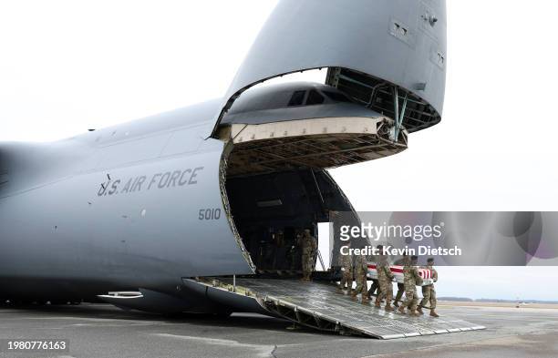 The flag draped transfer cases containing the remains of Sgt. Kennedy Sanders is moved during a dignified transfer at Dover Air Force Base on...