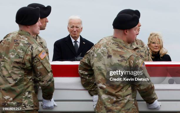 President Joe Biden and first lady Jill Biden pay their respects as a U.S. Army carry team moves a flagged draped transfer case containing the...