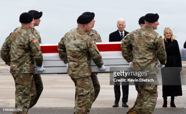 President Joe Biden and first lady Jill Biden pay their respects as a U.S. Army carry team moves a flagged draped transfer case containing the...