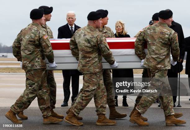 President Joe Biden and first lady Jill Biden pay their respects as a U.S. Army carry team moves a flagged draped transfer case containing the...