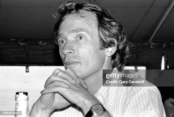 Close-up of American television host Dick Cavett seated at a table during an interview at the Dock Restaurant, Montauk Point, Long Island, New York,...