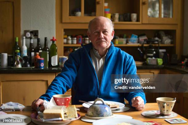 senior man enjoying a light lunch - shaved cheese stock pictures, royalty-free photos & images