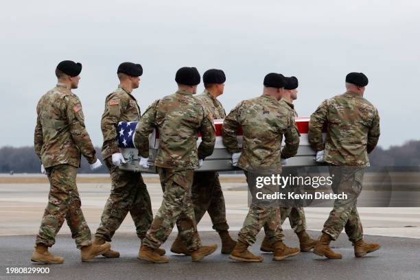 Army carry team moves a flagged draped transfer case containing the remains of Army Sgt. Breonna Moffett during a dignified transfer at Dover Air...