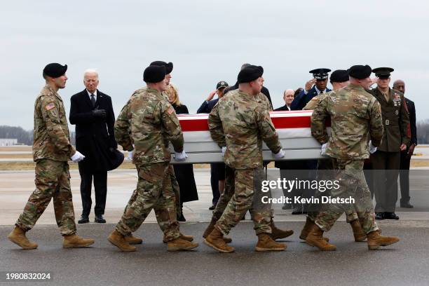 Army carry team moves a flagged draped transfer case containing the remains of Army Sgt. Kennedy Sanders during a dignified transfer at Dover Air...