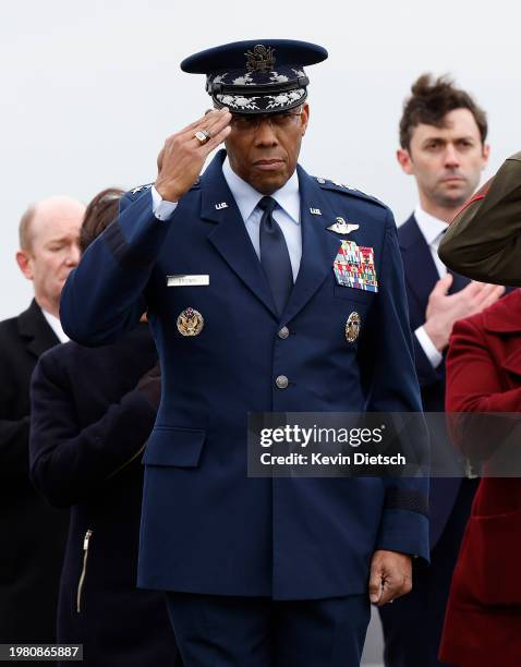 Chairman of the Joint Chiefs of Staff Air Force Gen. Charles Q. Brown salutes during the dignified transfer for fallen service members U.S. Army Sgt....